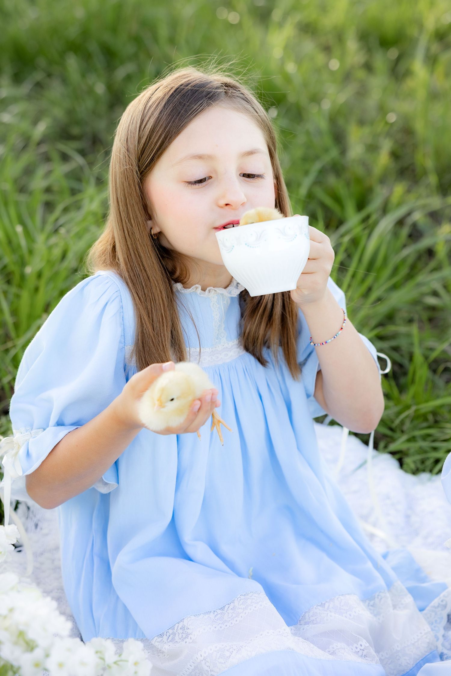 Spring Mini Session with baby chicks in a grass field at sunset near Dothan, Alabama