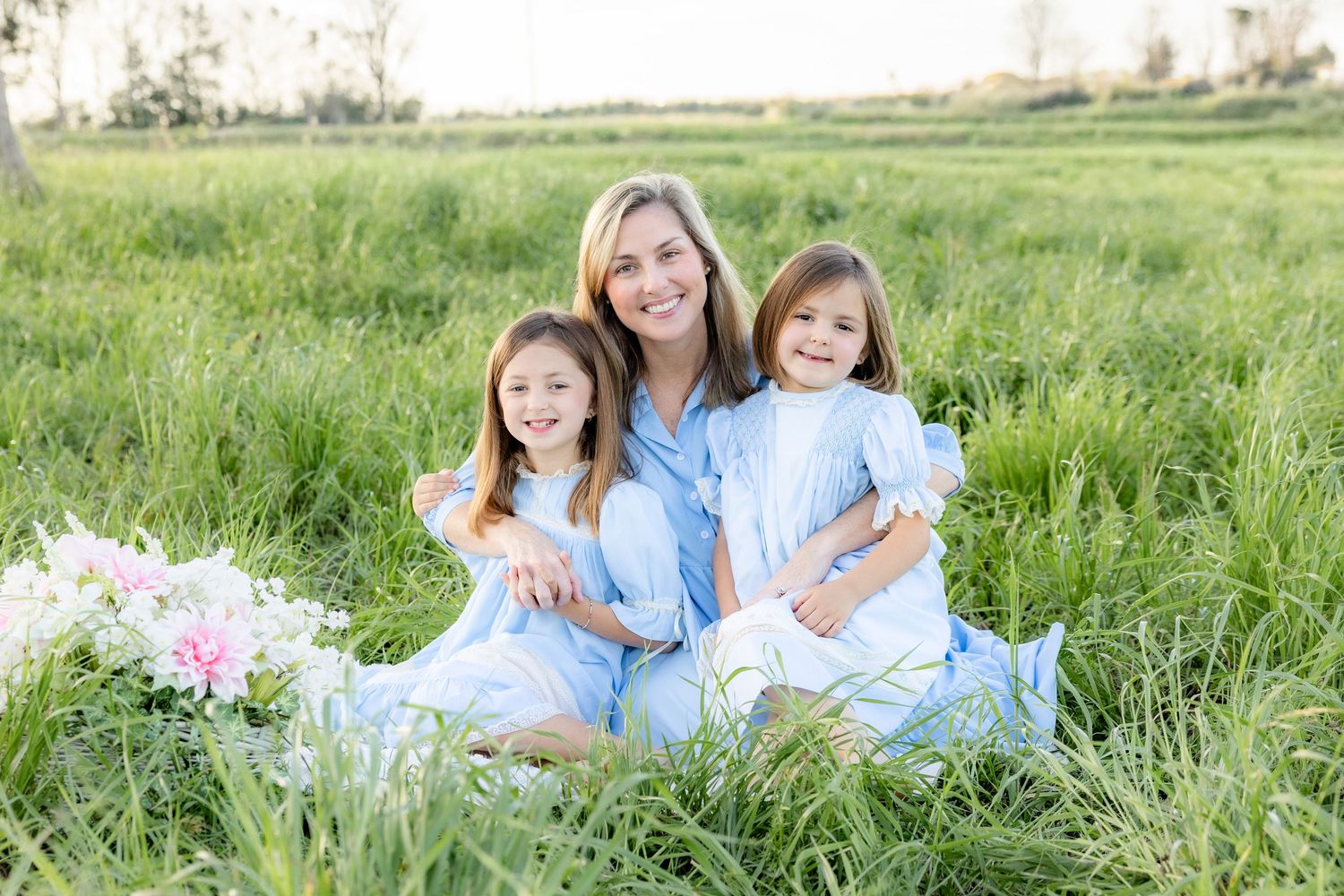 Spring Mini Session with baby chicks in a grass field at sunset near Dothan, Alabama