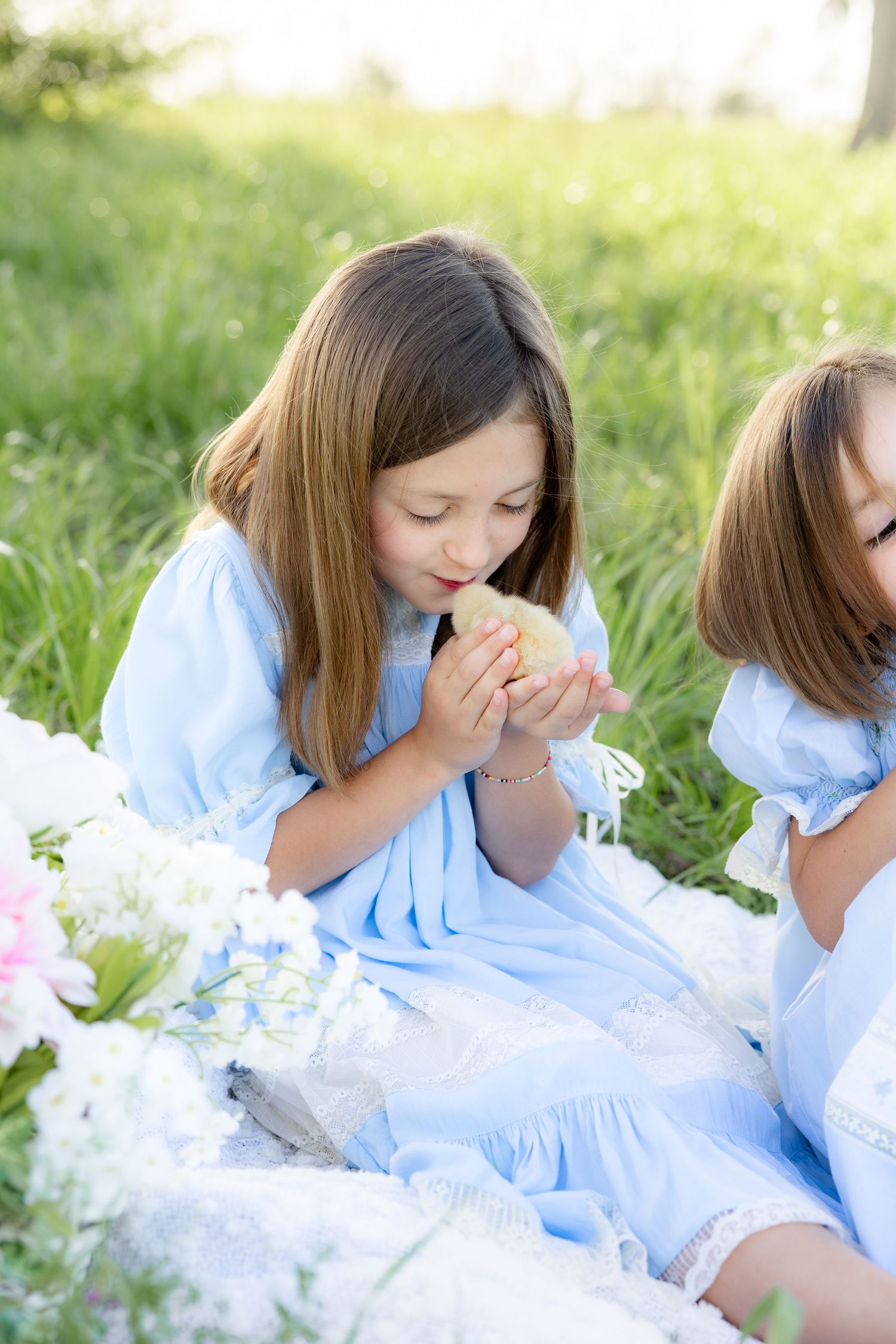 Spring Mini Session with baby chicks in a grass field at sunset near Dothan, Alabama
