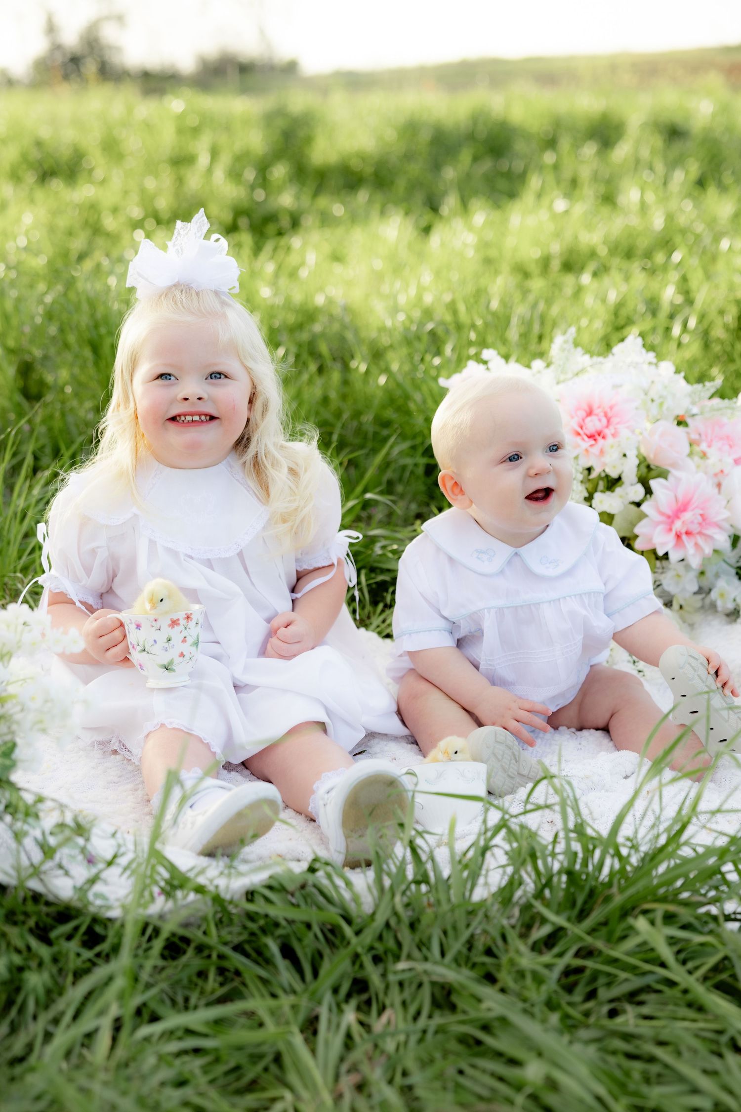 Spring Mini Session with baby chicks in a grass field at sunset near Dothan, Alabama