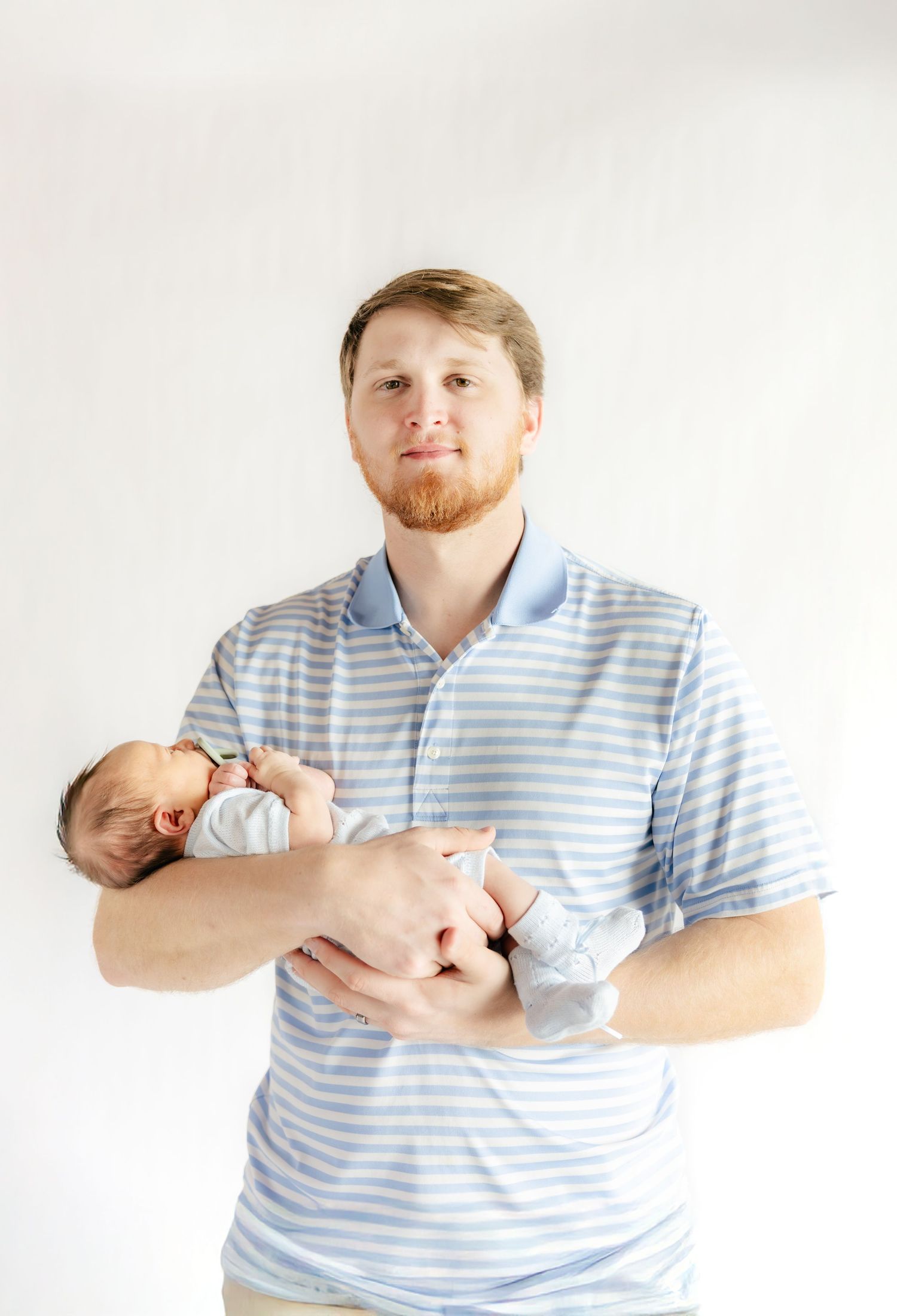 Father holding his baby in a studio in Dothan, Alabama