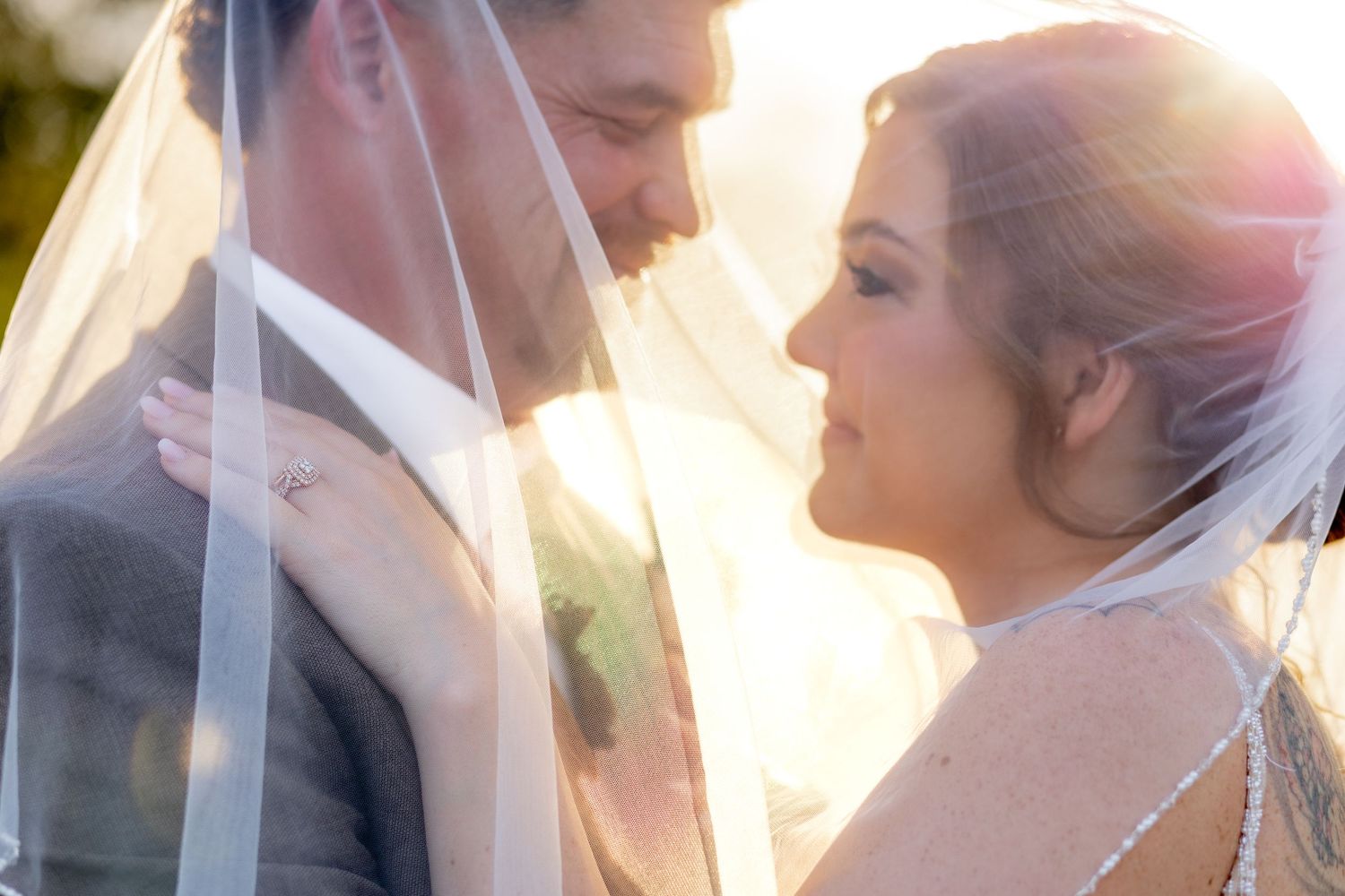 Bride and groom under the veil at sunset at Hilltop Acres Wicksburg, Alabama