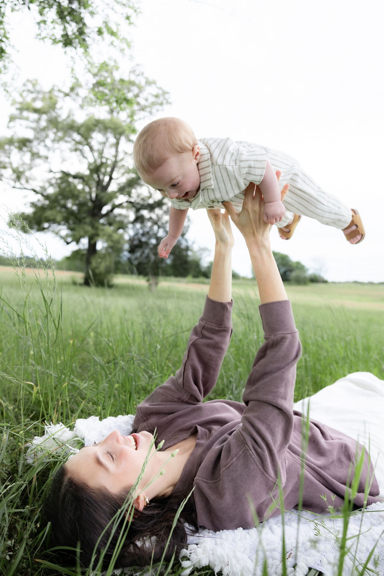 Candid family photos in a grass field | Dothan, Alabama Lifestyle Portrait Photographer