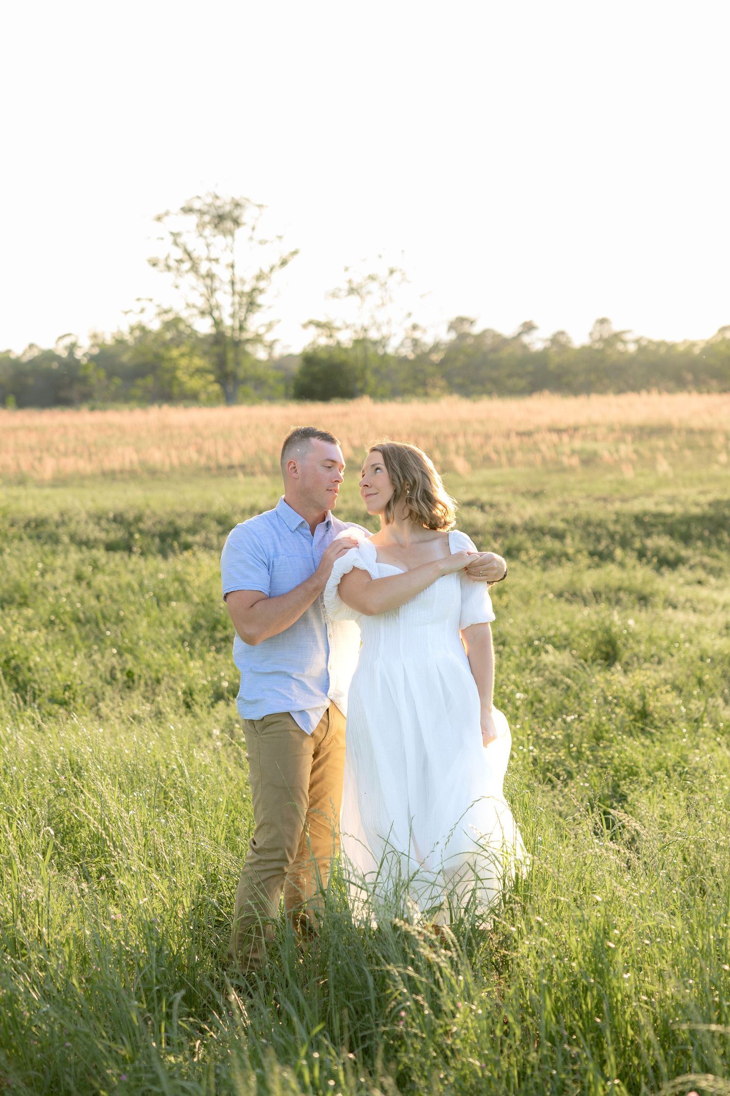 Storytelling couple photos in a tall grass field at sunset in Dothan, Alabama