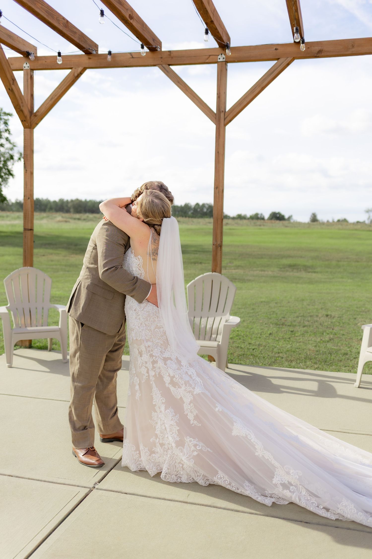 Groom first look with bride underneath the gazebo at Hilltop Acres Wicksburg, Alabama