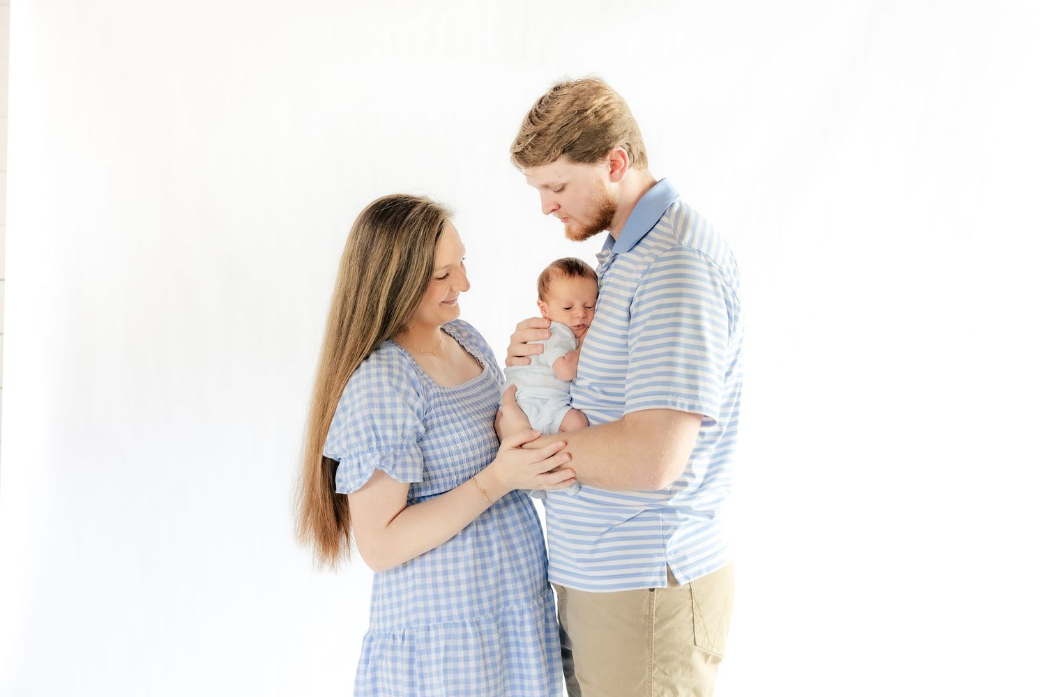 Family holding their baby in a studio in Dothan, Alabama