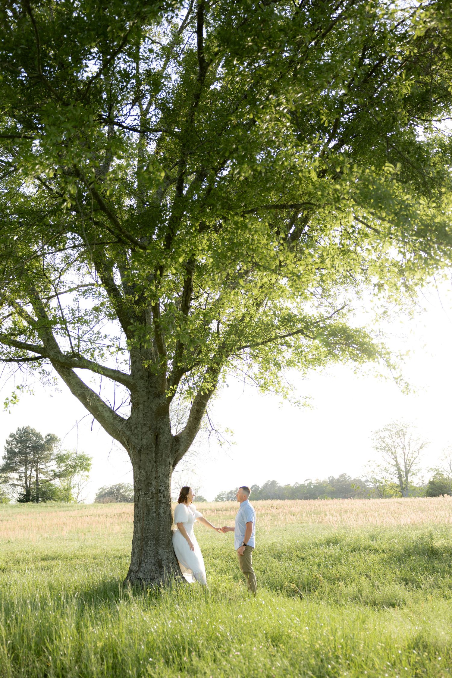 Storytelling romantic couple photos in a tall grass field at sunset in Dothan, Alabama