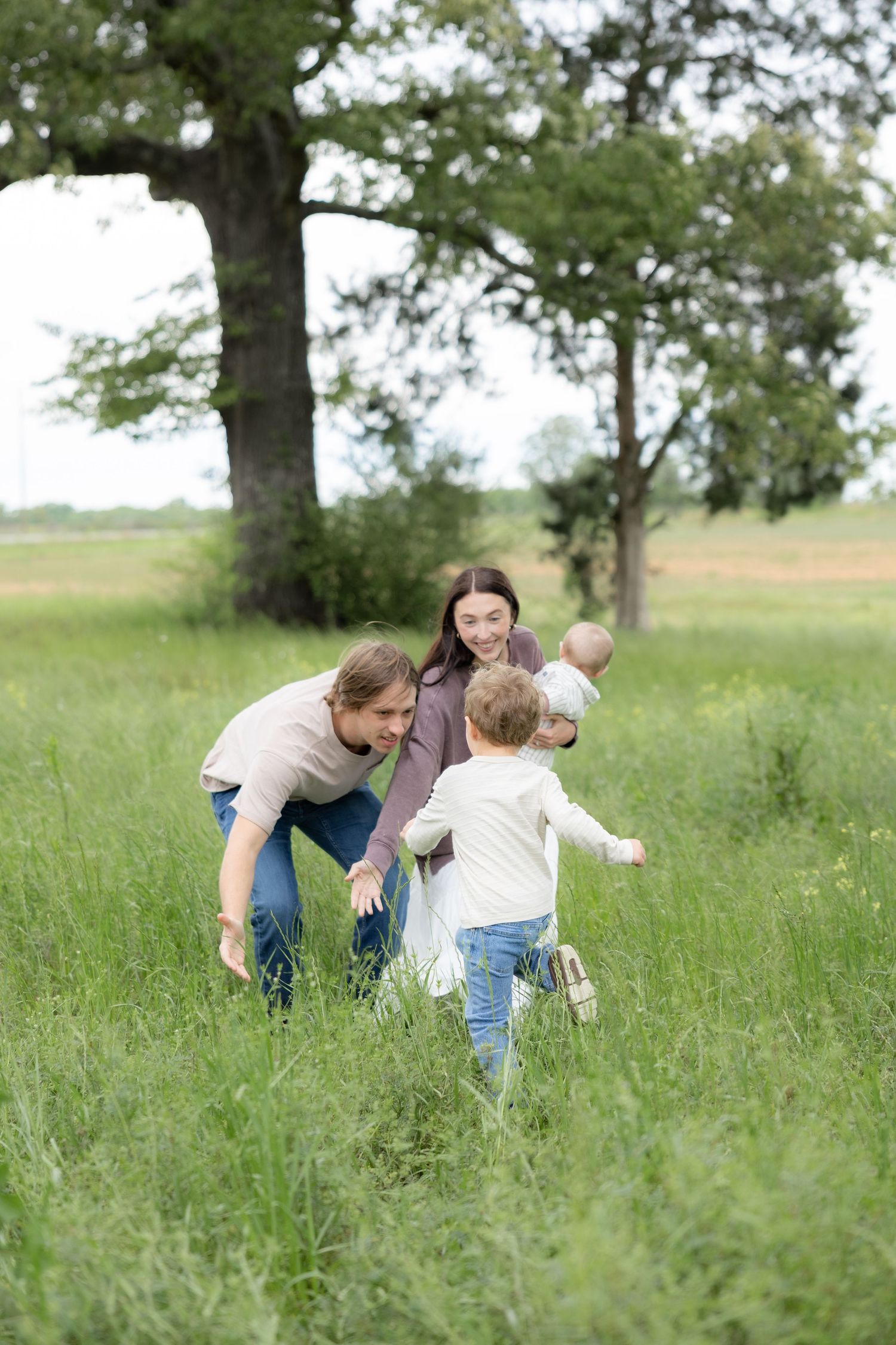 Candid family photos in a grass field | Dothan, Alabama Lifestyle Portrait Photographer