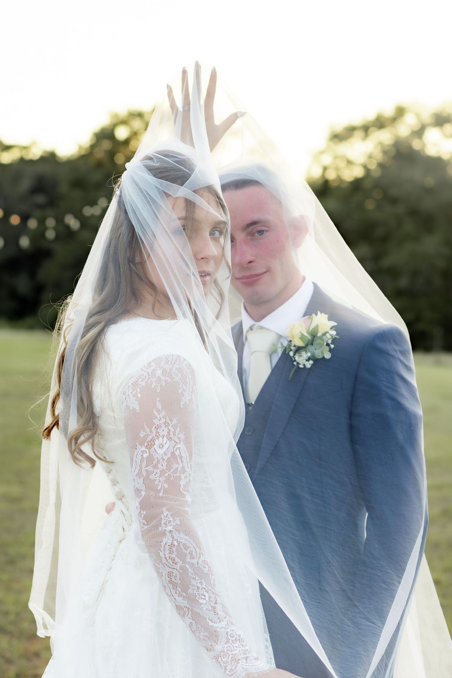 Bride and groom pose under the veil for portraits at Dalrymple Farms Enterprise, Alabama