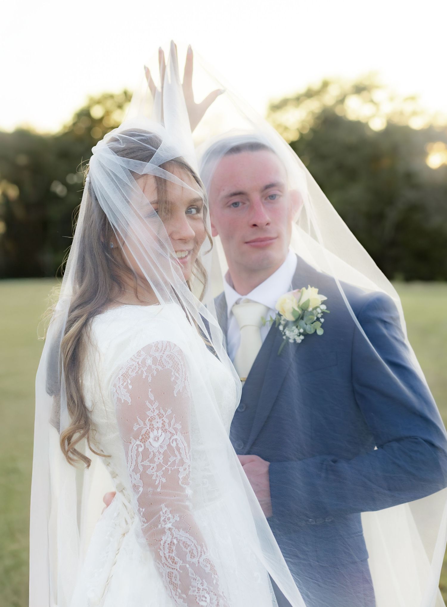 Bride and groom pose under the veil for portraits at Dalrymple Farms Enterprise, Alabama