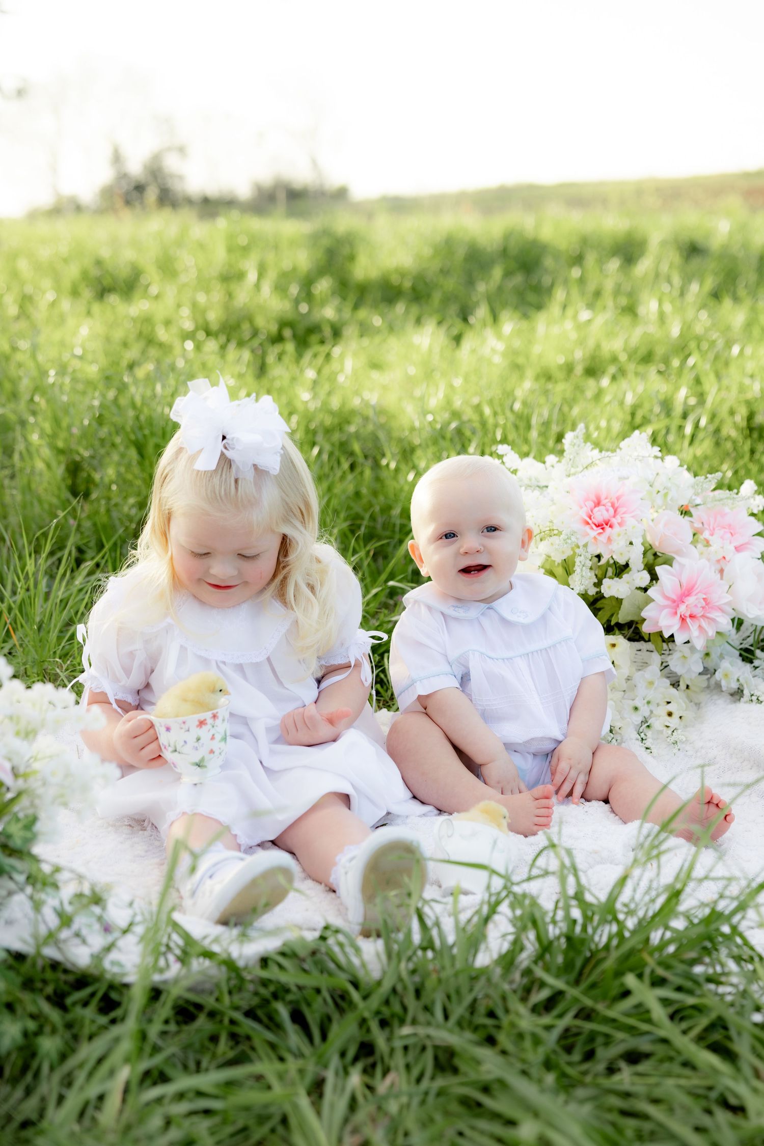 Spring Mini Session with baby chicks in a grass field at sunset near Dothan, Alabama