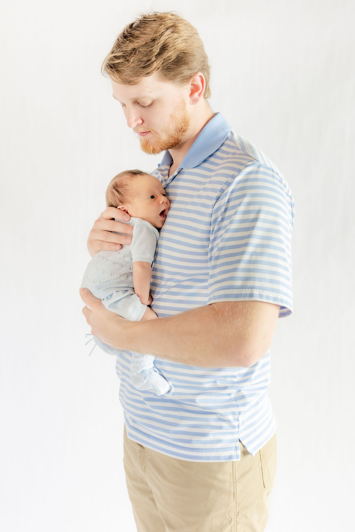 Father holding his baby in a studio in Dothan, Alabama
