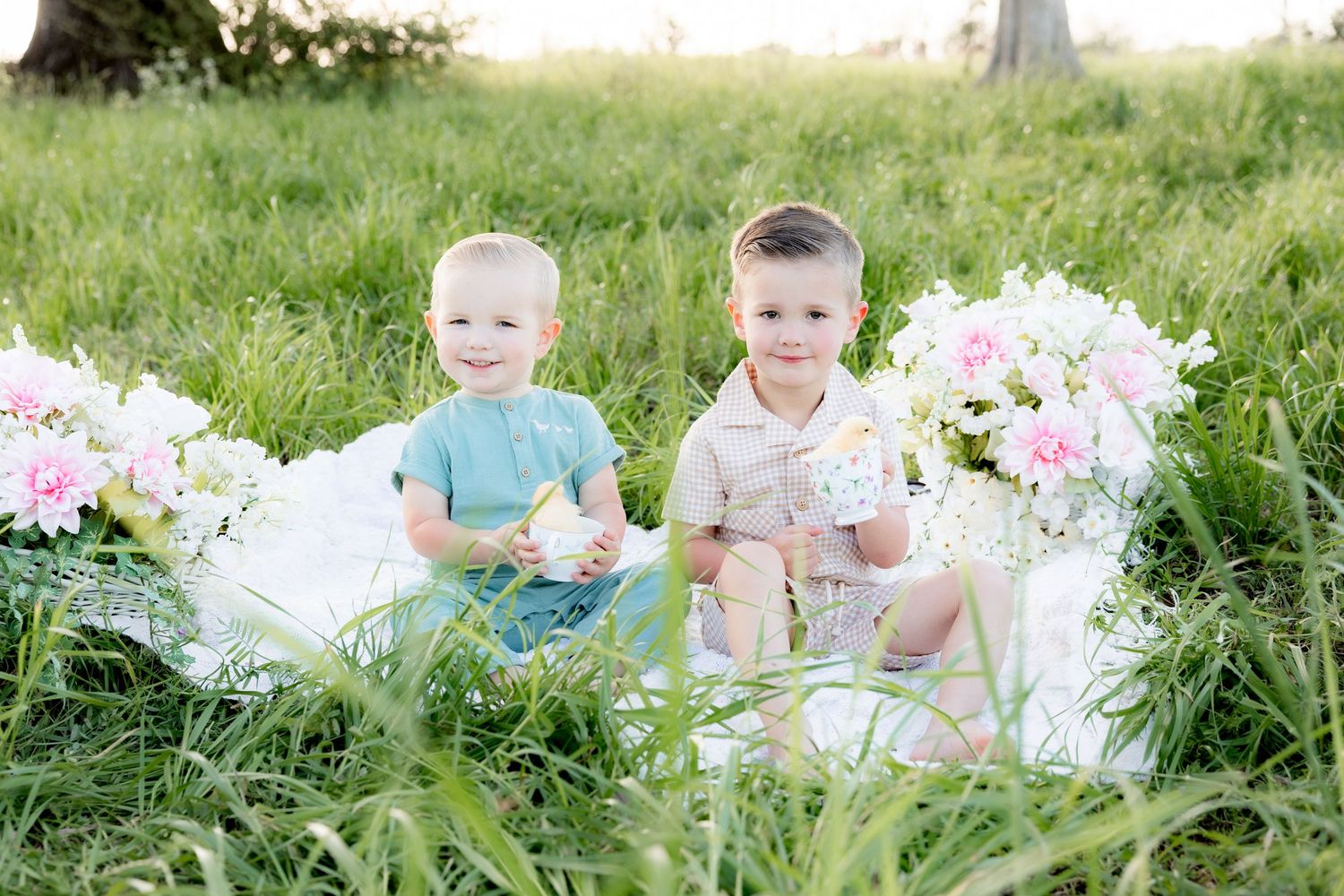 Spring Mini Session with baby chicks in a grass field at sunset near Dothan, Alabama