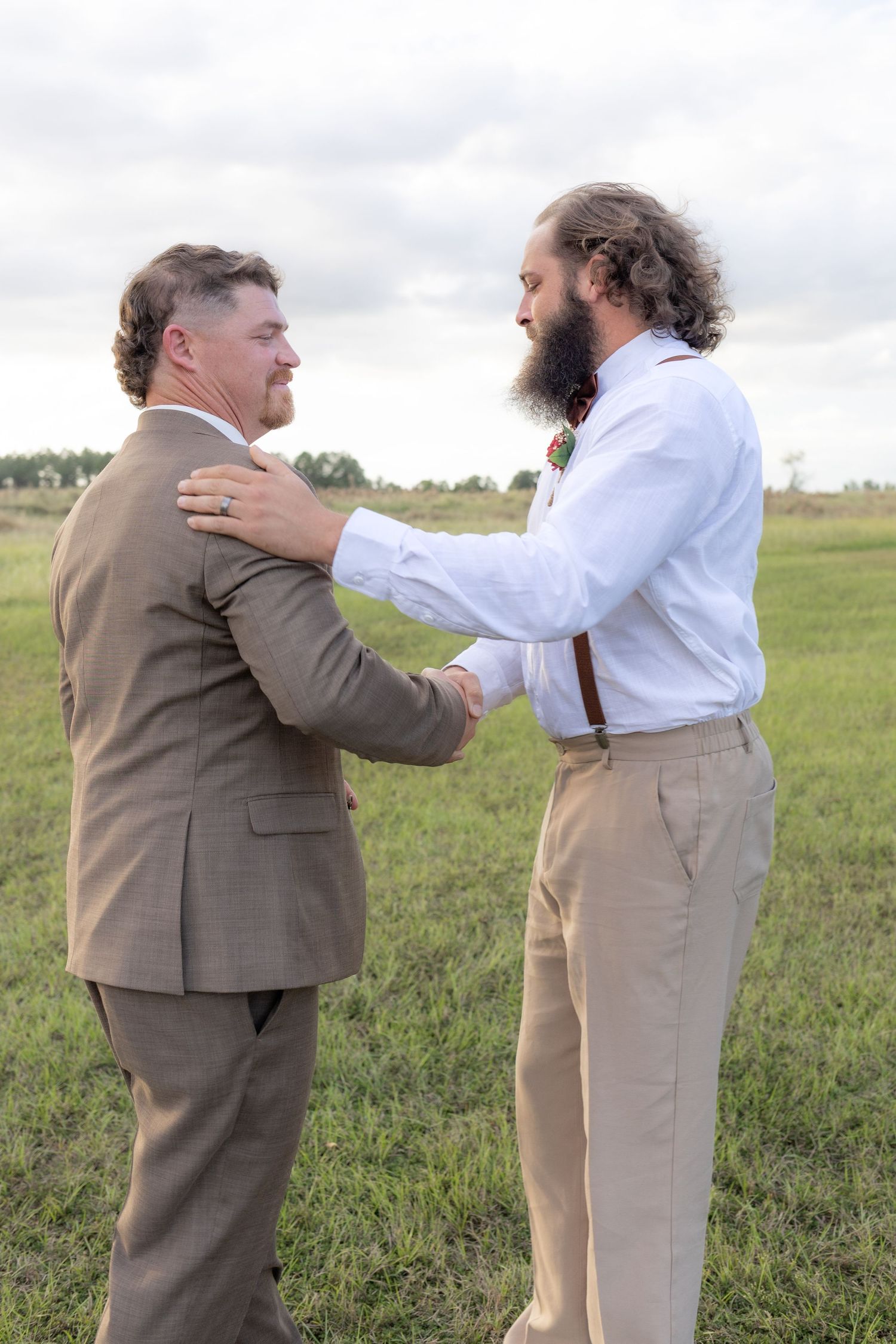 Bride's brother shaking the groom's hand before the wedding at Hilltop Acres Wicksburg, Alabama