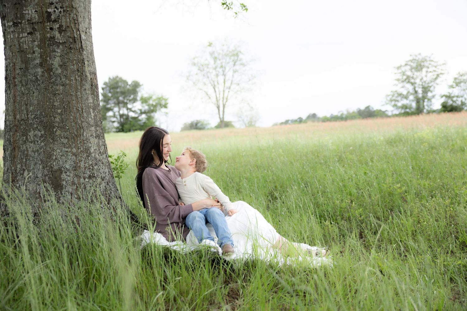 Candid family photos in a grass field | Dothan, Alabama Lifestyle Portrait Photographer