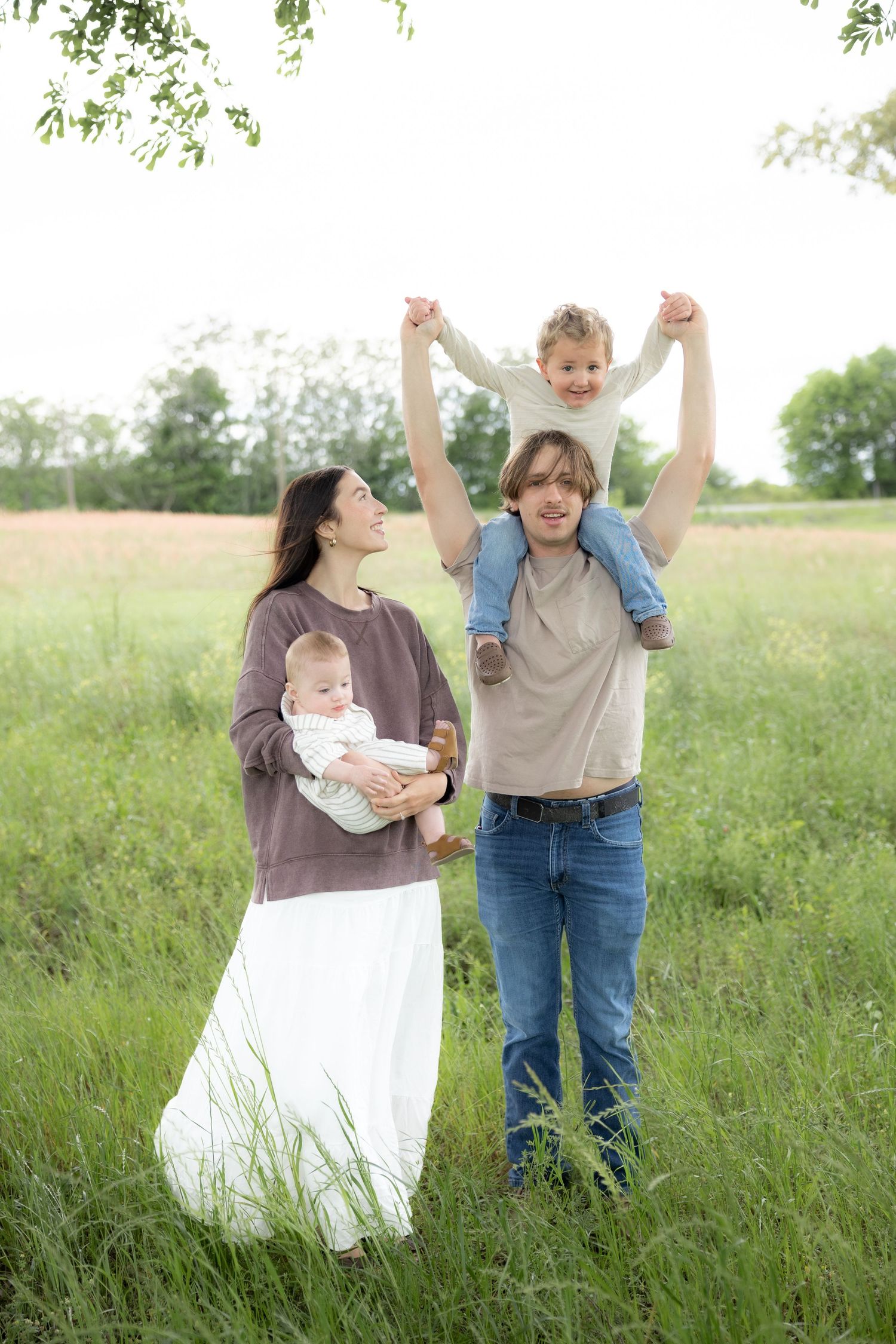 Candid family photos in a grass field | Dothan, Alabama Lifestyle Portrait Photographer