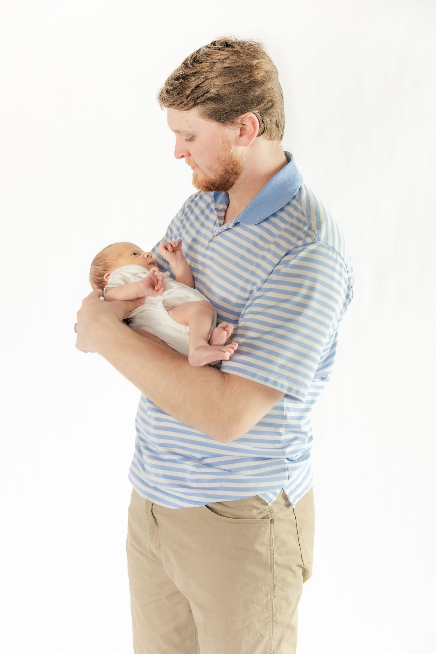 Father holding his baby in a Studio in Dothan, Alabama
