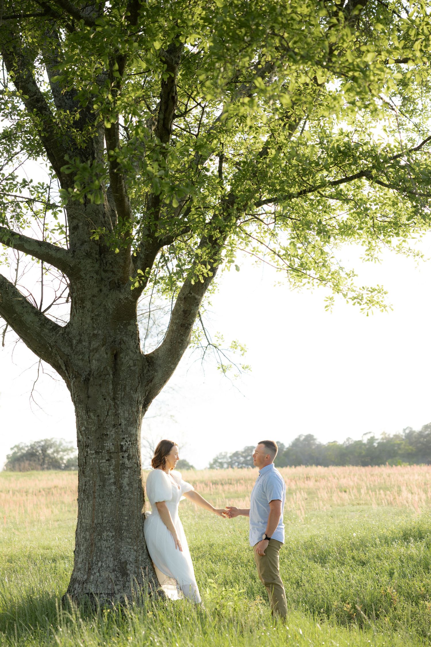 Storytelling romantic couple photos in a tall grass field at sunset in Dothan, Alabama