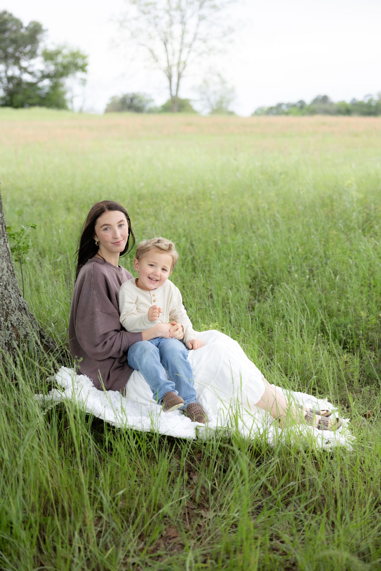 Candid family photos in a grass field | Dothan, Alabama Lifestyle Portrait Photographer