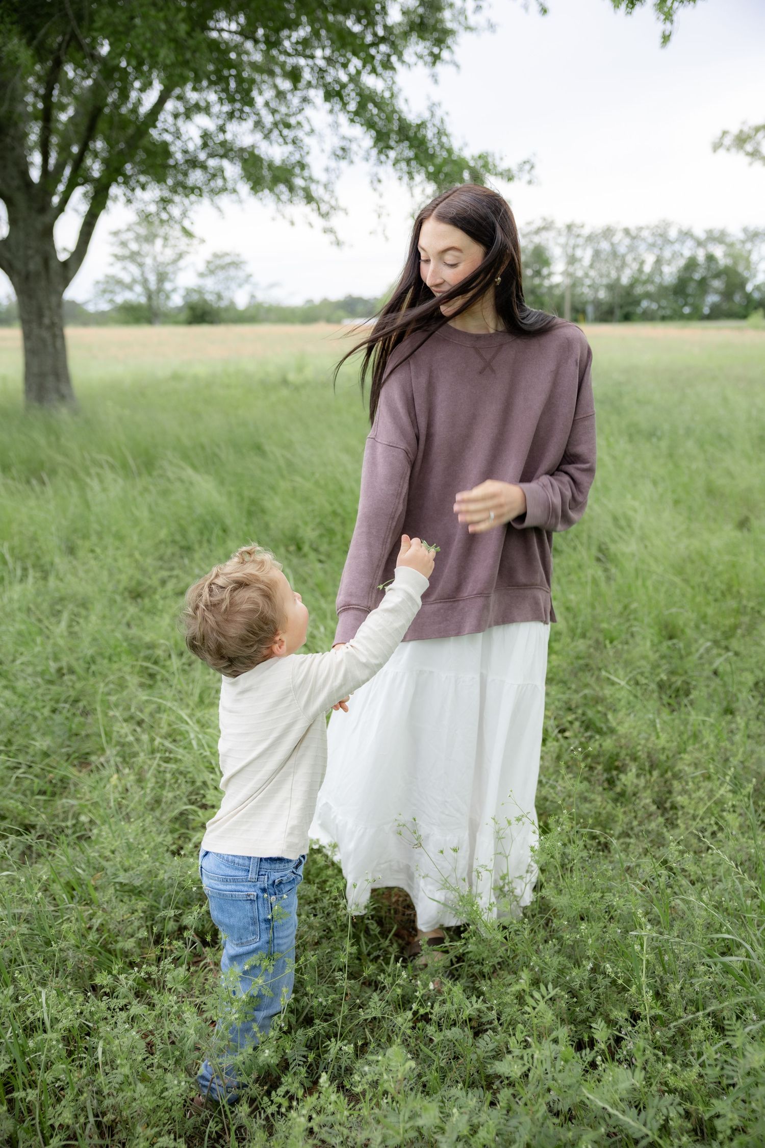 Candid family photos in a grass field | Dothan, Alabama Lifestyle Portrait Photographer