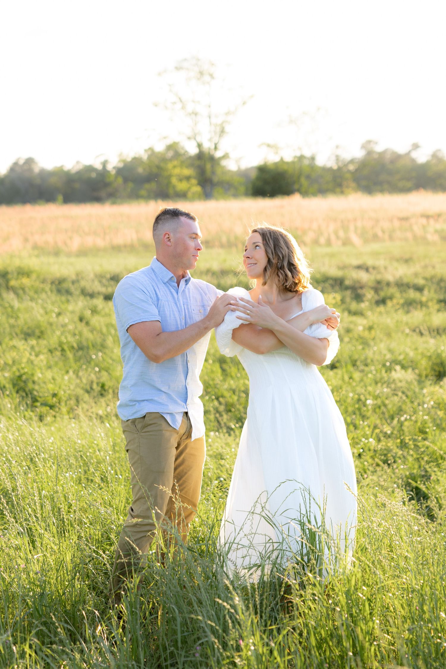 Storytelling couple photos in a tall grass field at sunset in Dothan, Alabama