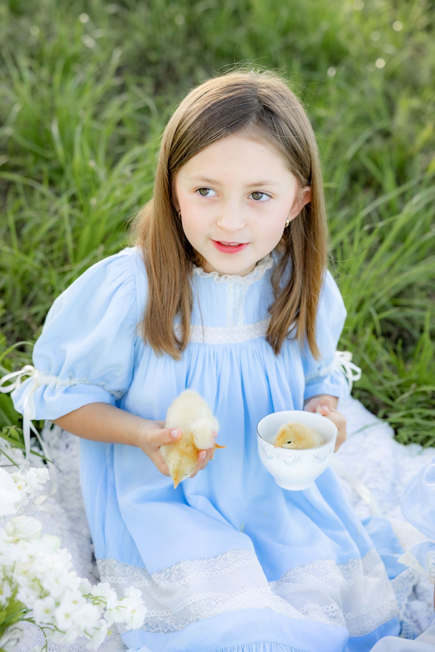 Spring Mini Session with baby chicks in a grass field at sunset near Dothan, Alabama