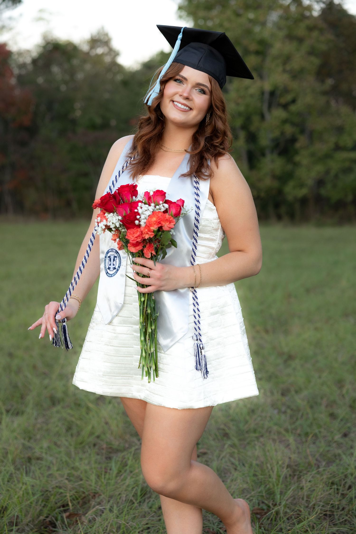Senior pictures at sunset in a field at Troy University Dothan Campus