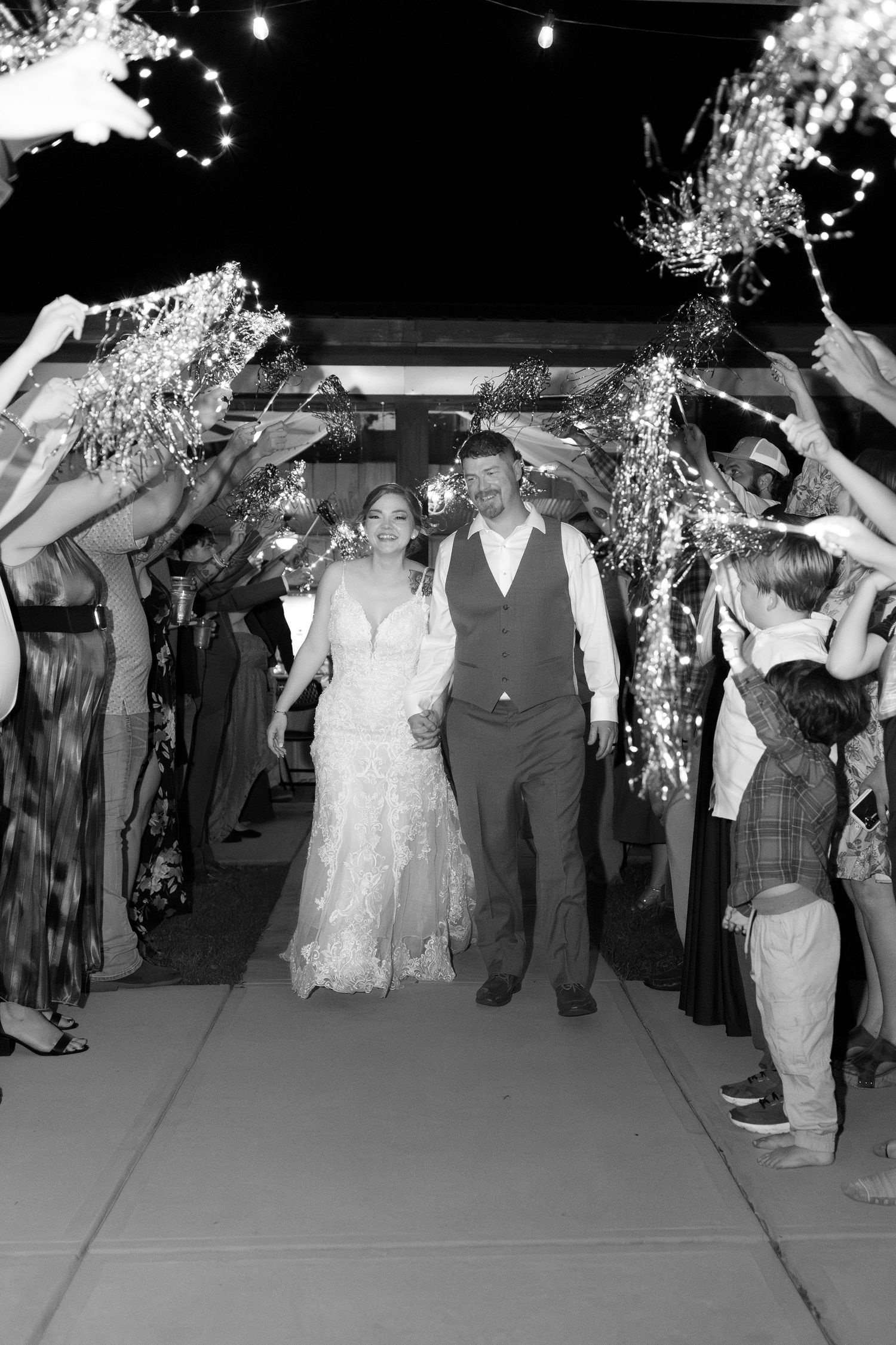 Bride and groom exit through sparklers at their wedding at Hilltop Acres Wicksburg, Alabama
