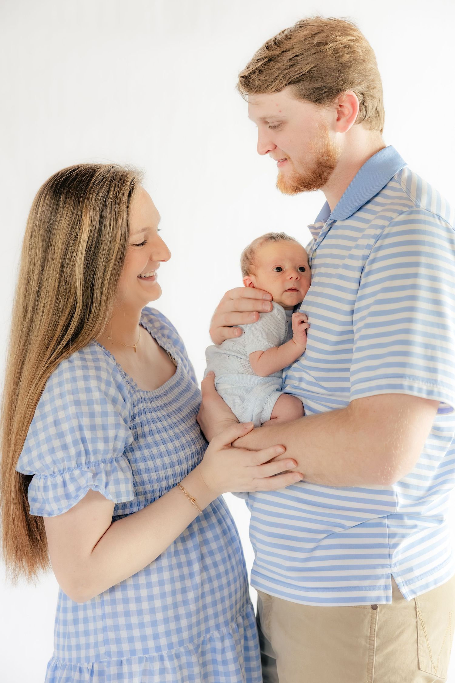 Family holding their baby in a studio in Dothan, Alabama