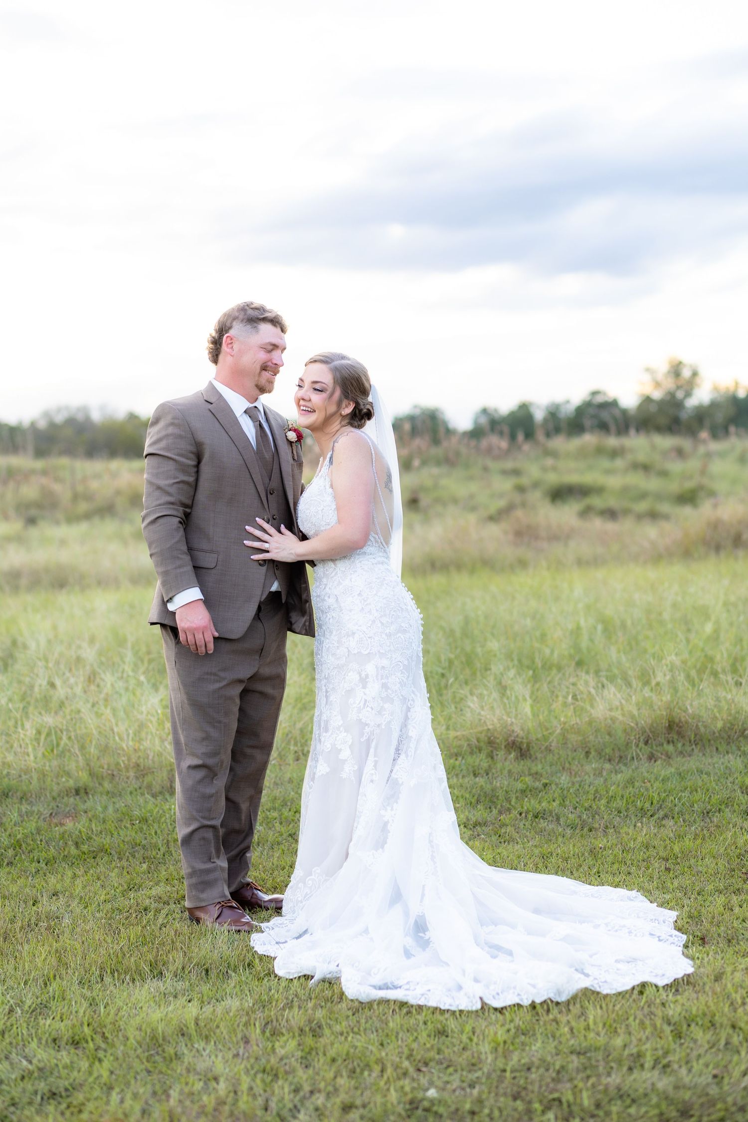 Bride and groom hold each other at sunset at Hilltop Acres Wicksburg, Alabama