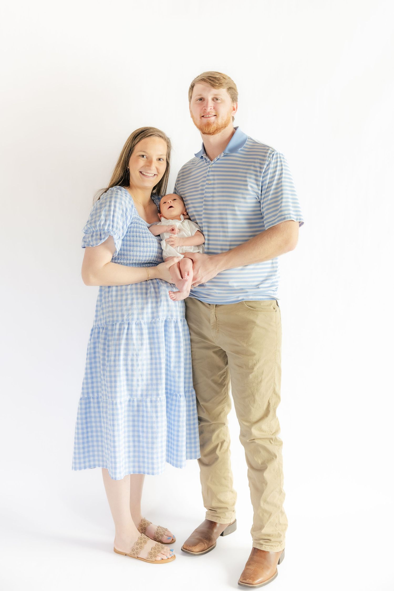 Family holding their newborn in a studio in Dothan, Alabama