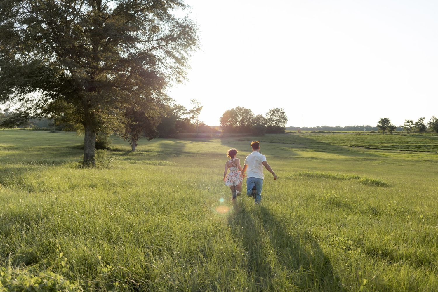 Romantic Couples photos in a tall grass field at sunset near Dothan, Alabama