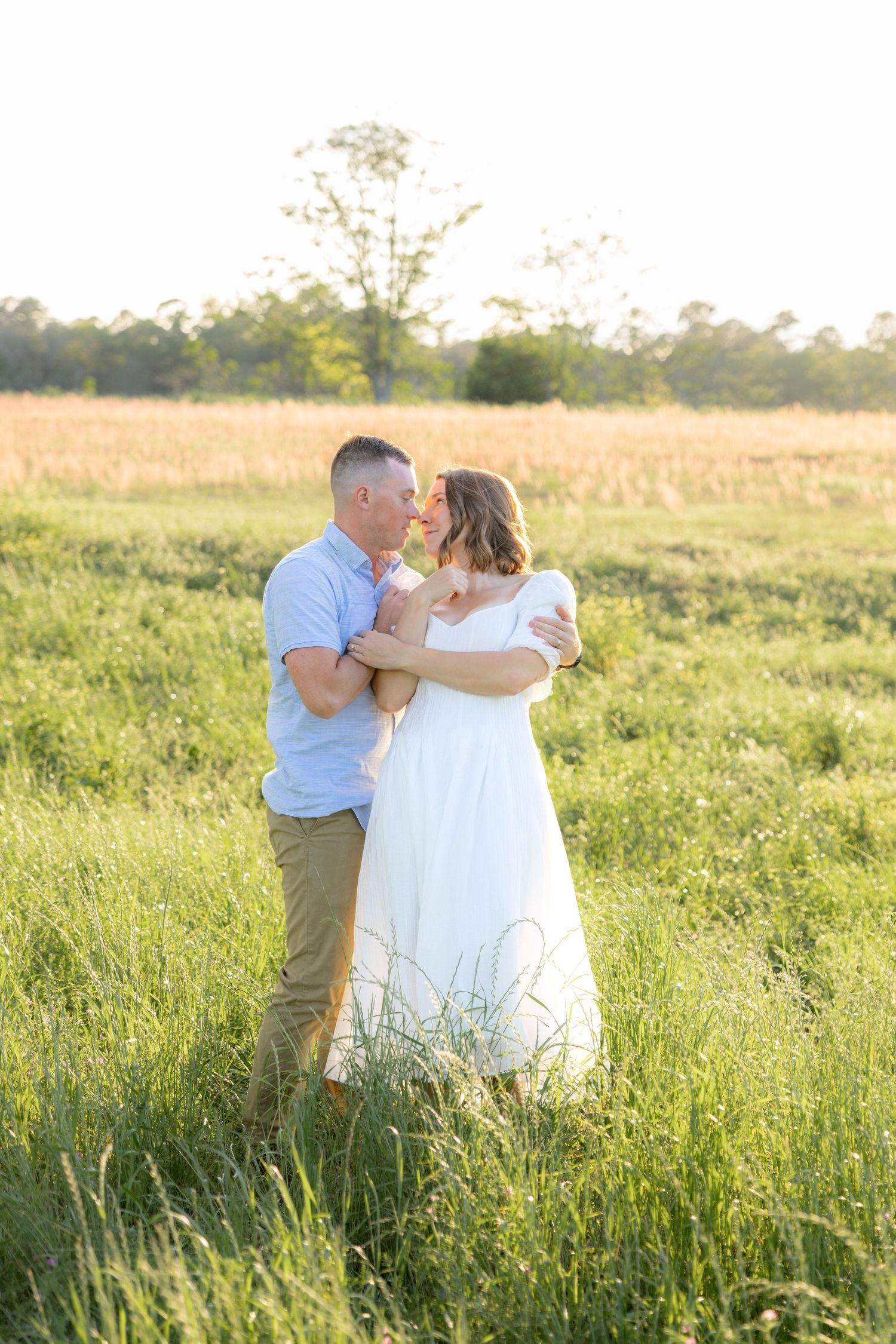 Storytelling couple photos in a tall grass field at sunset in Dothan, Alabama