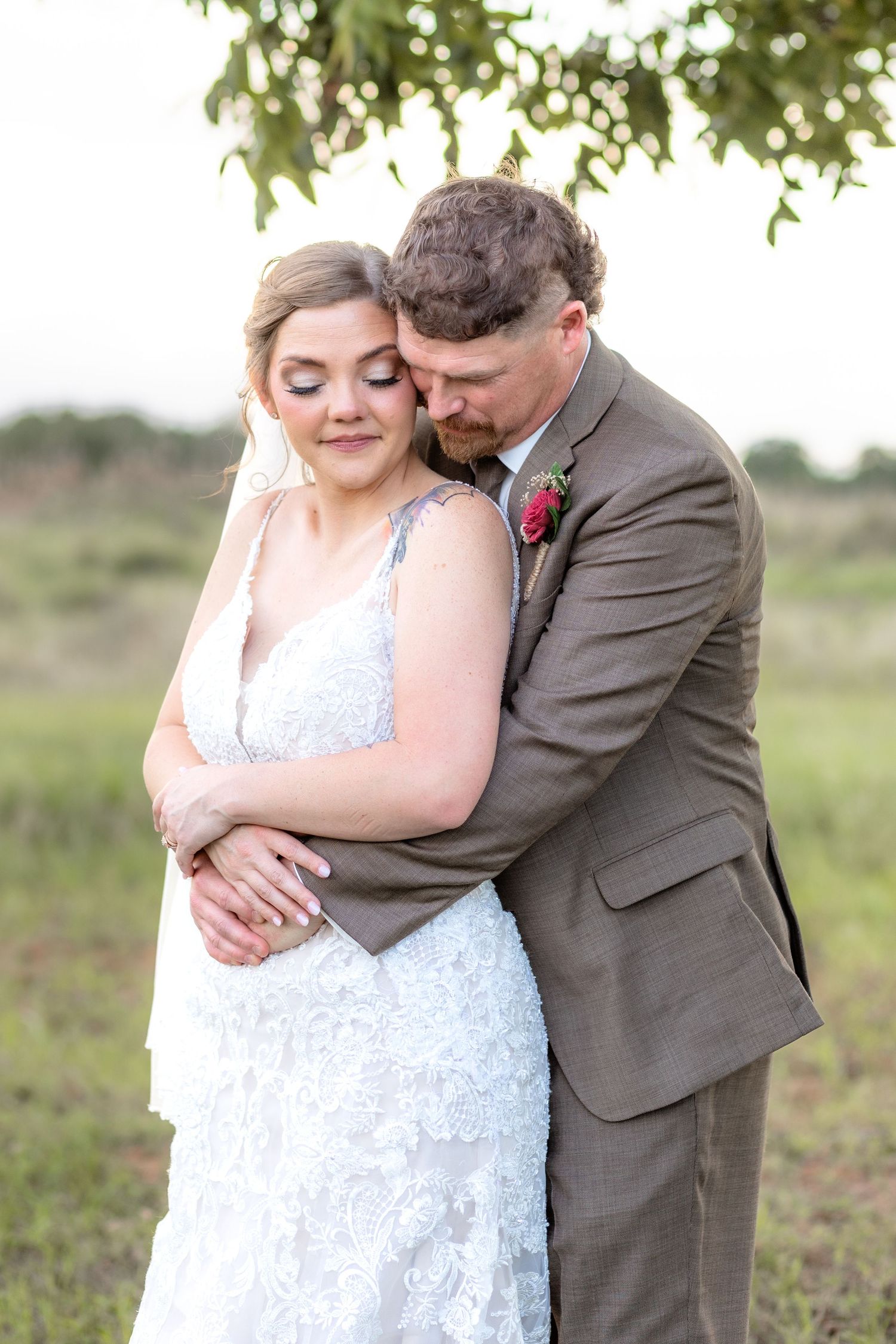 Bride and groom hold each other at sunset at Hilltop Acres Wicksburg, Alabama
