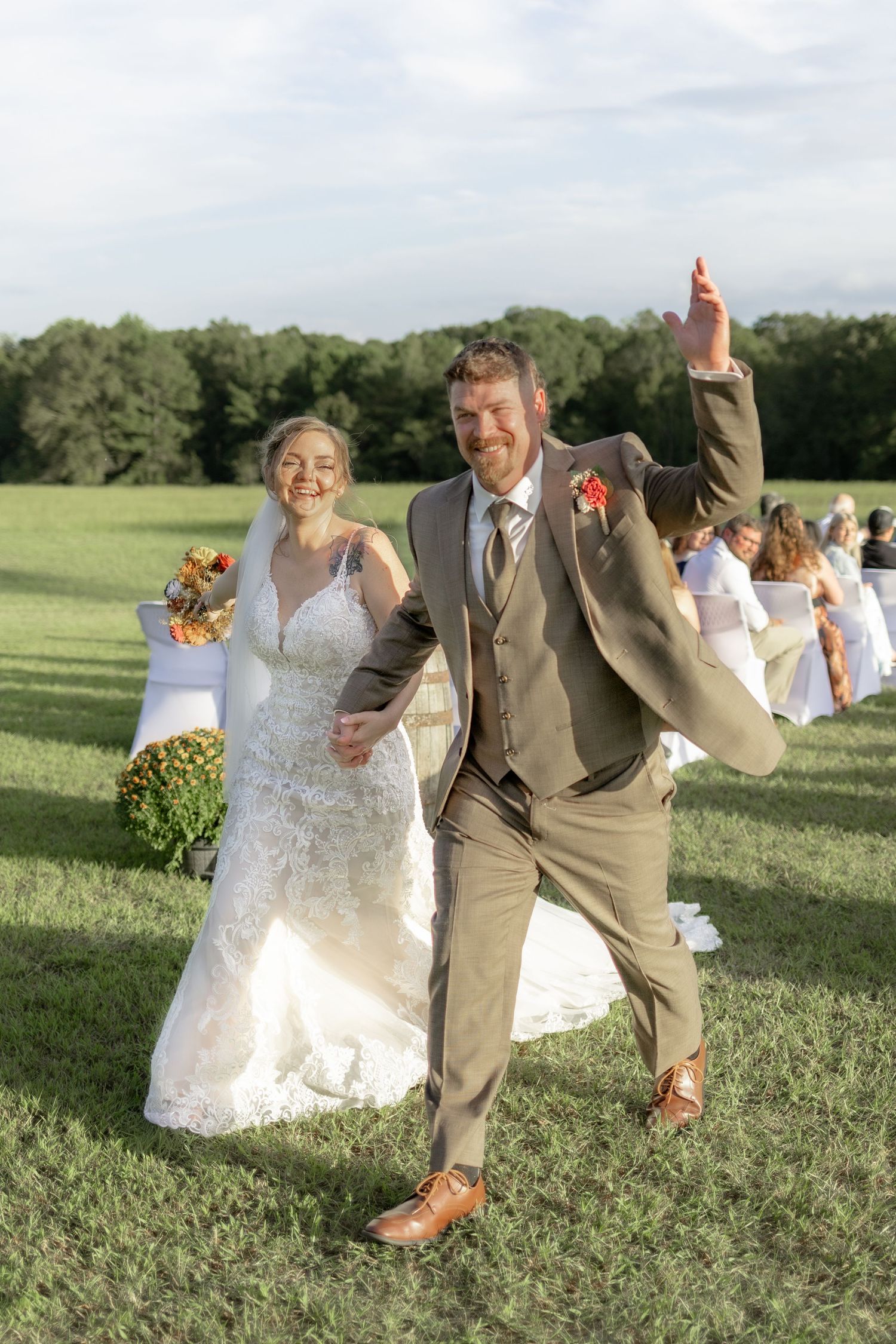 Bride and groom exiting their ceremony at Hilltop Acres Wicksburg, Alabama