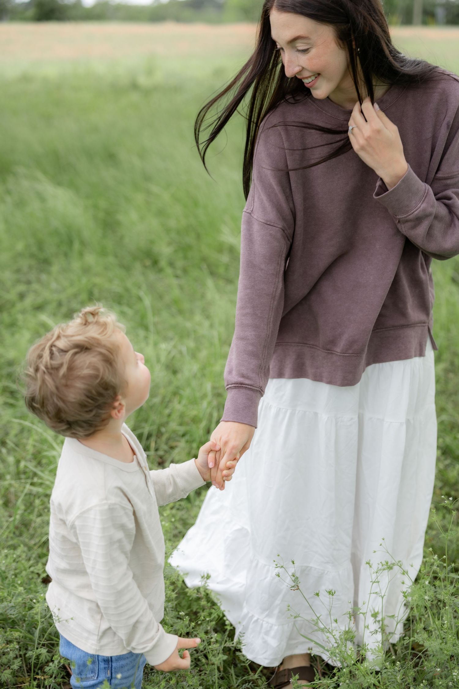 Candid family photos in a grass field | Dothan, Alabama Lifestyle Portrait Photographer