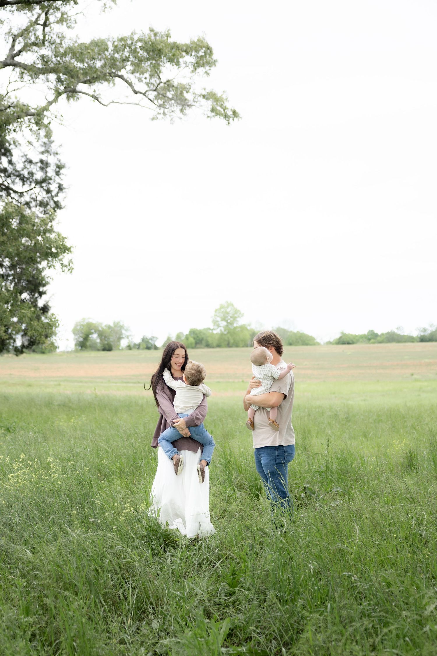 Candid family photos in a grass field | Dothan, Alabama Lifestyle Portrait Photographer