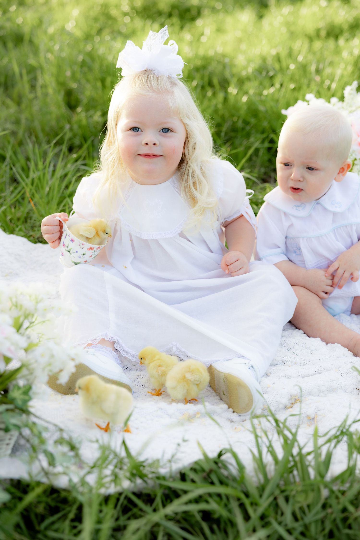 Spring Mini Session with baby chicks in a grass field at sunset near Dothan, Alabama
