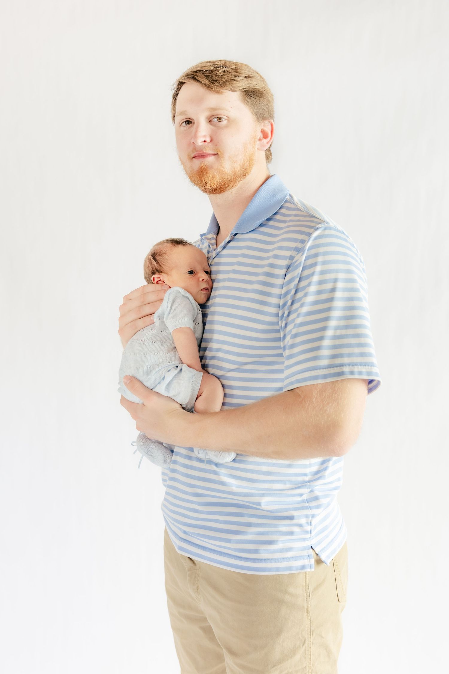 Father holding his baby in a studio in Dothan, Alabama