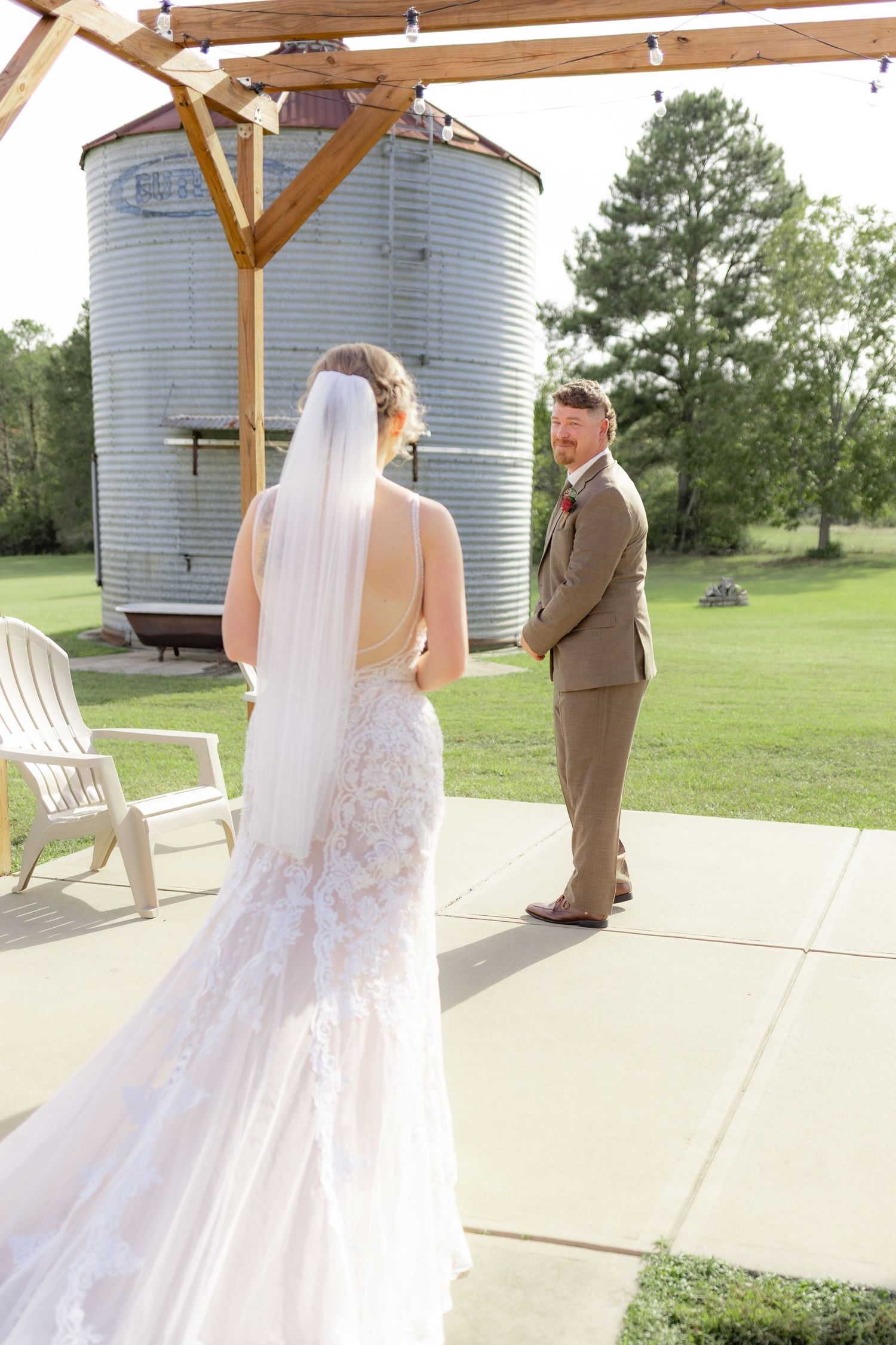 Groom first look with bride underneath the gazebo at Hilltop Acres Wicksburg, Alabama