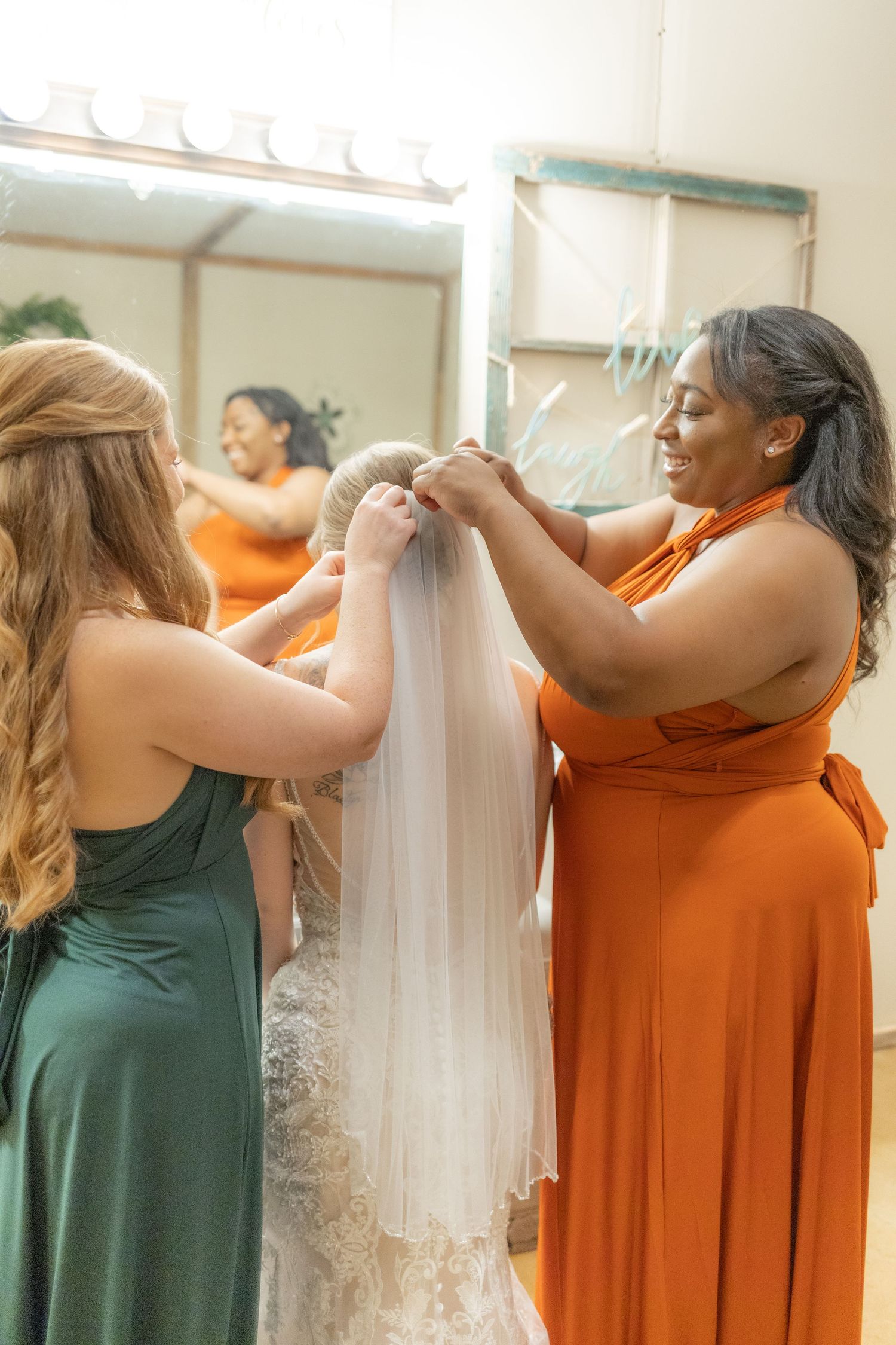 Bridesmaids helping bride get ready on her wedding day at Hilltop Acres Wicksburg, Alabama