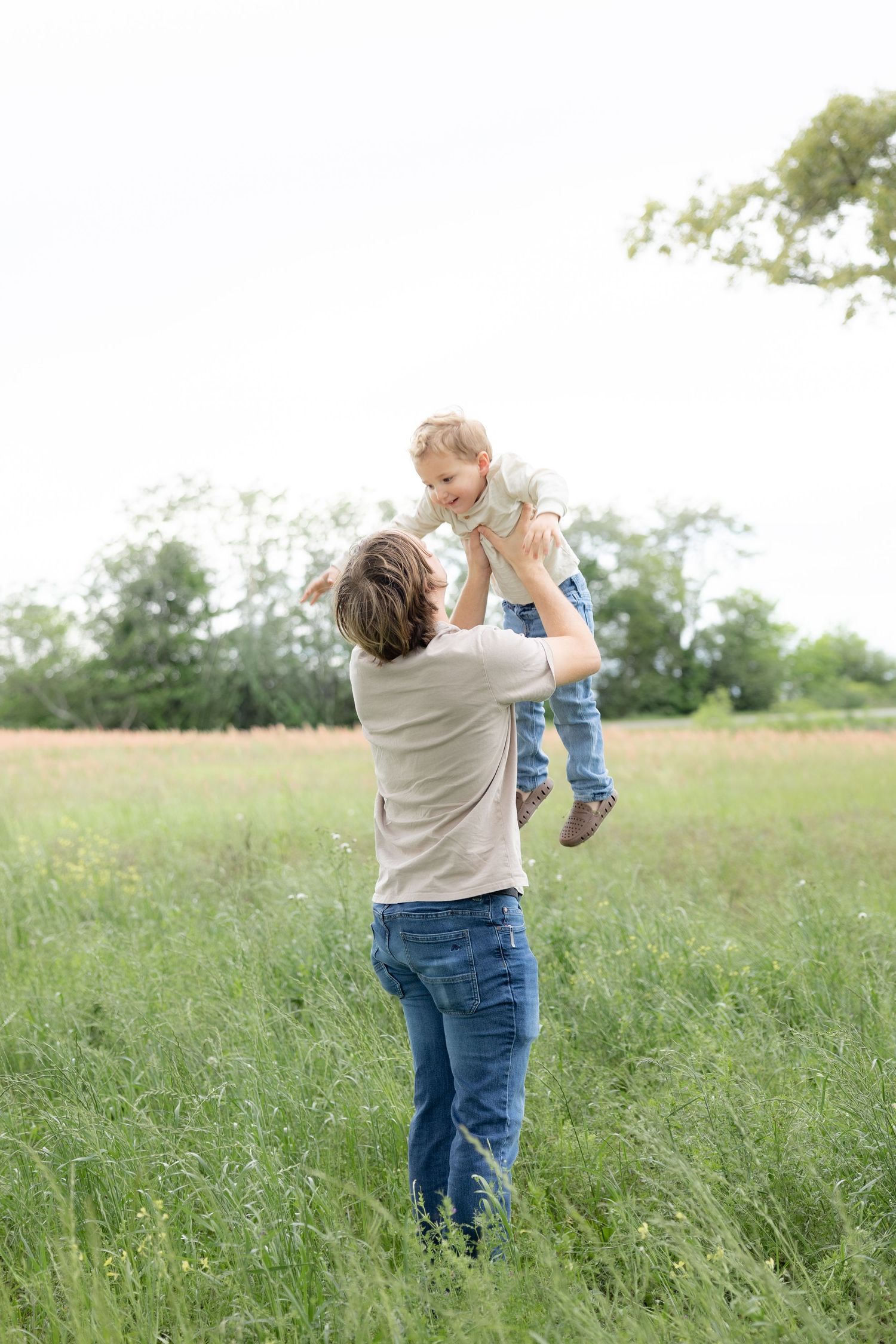 Candid family photos in a grass field | Dothan, Alabama Lifestyle Portrait Photographer