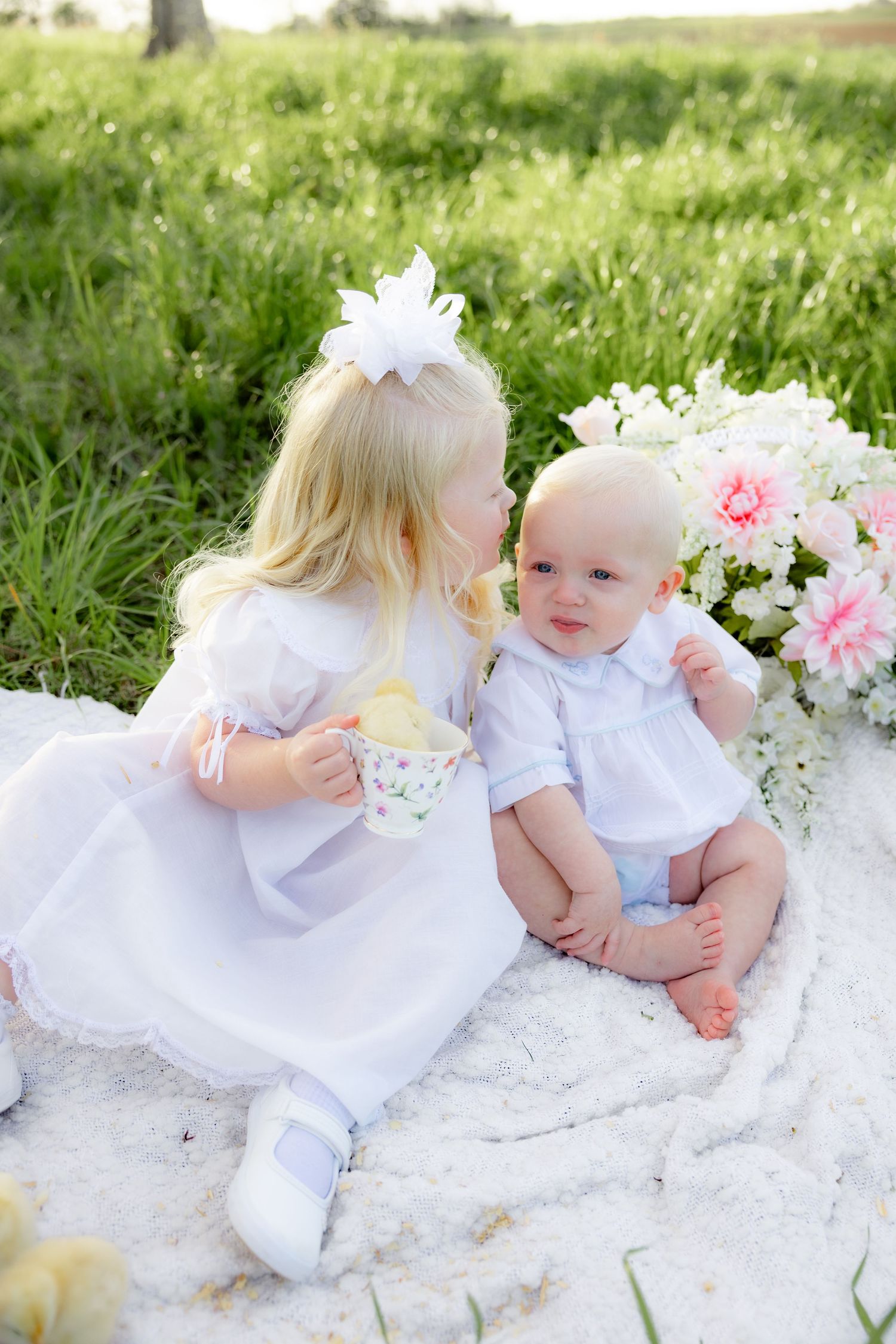 Spring Mini Session with baby chicks in a grass field at sunset near Dothan, Alabama