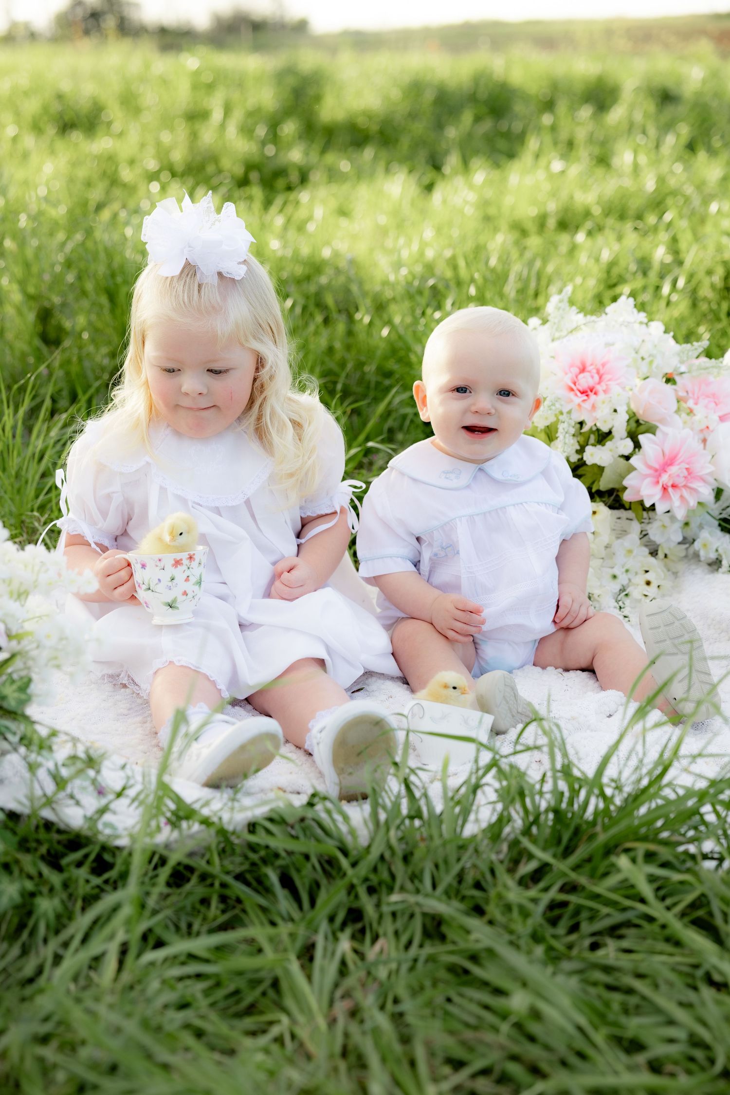 Spring Mini Session with baby chicks in a grass field at sunset near Dothan, Alabama