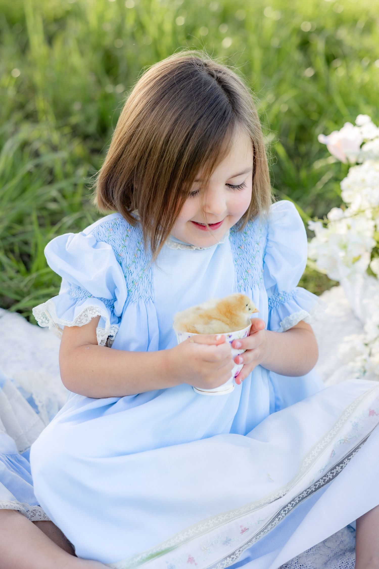 Spring Mini Session with baby chicks in a grass field at sunset near Dothan, Alabama