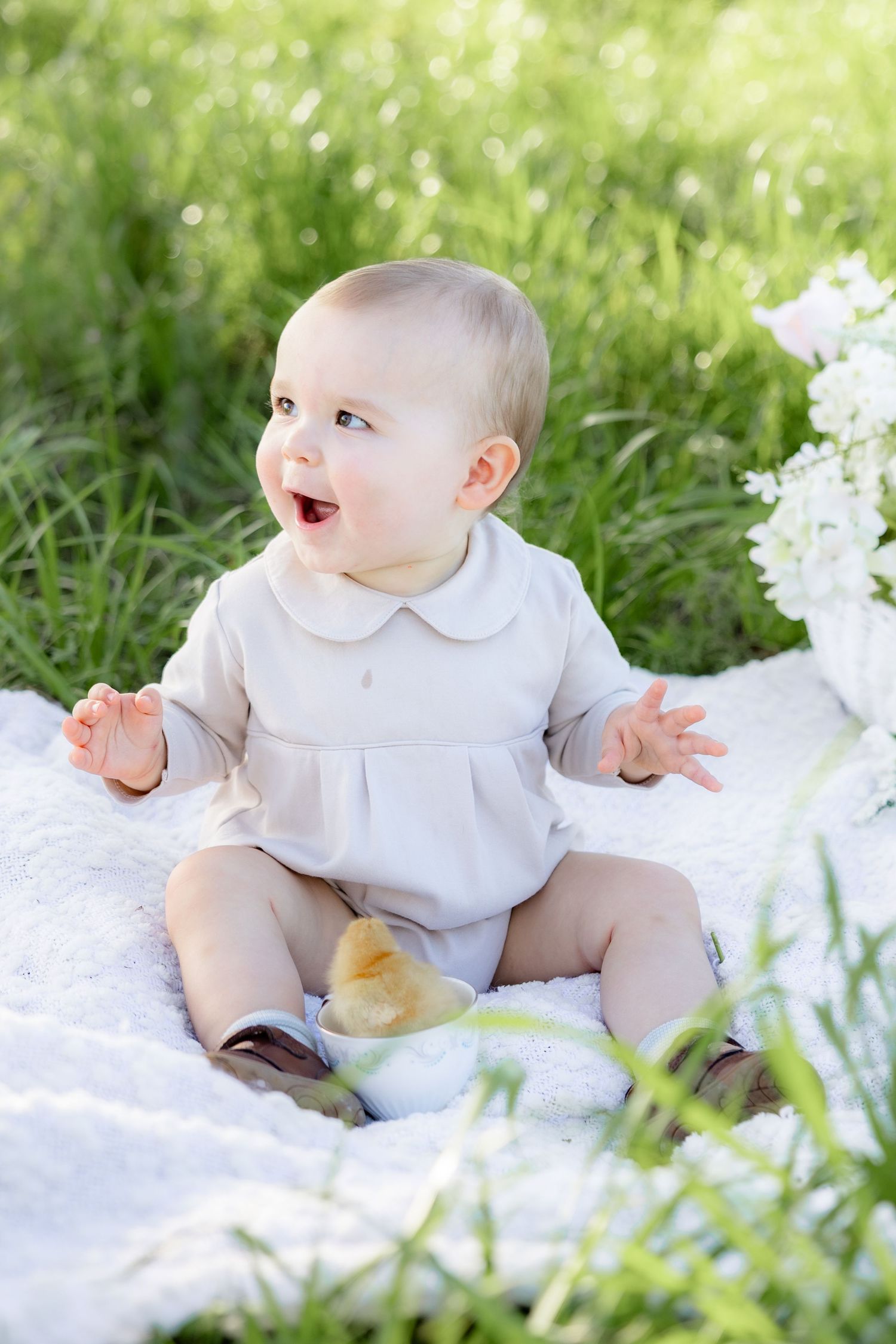 Spring Mini Session with baby chicks in a grass field at sunset near Dothan, Alabama
