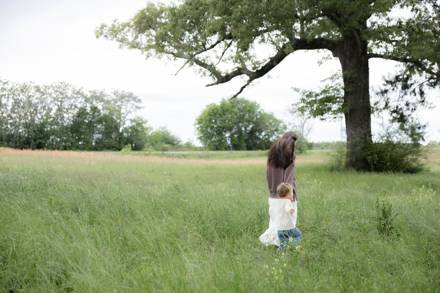 Candid family photos in a grass field | Dothan, Alabama Lifestyle Portrait Photographer