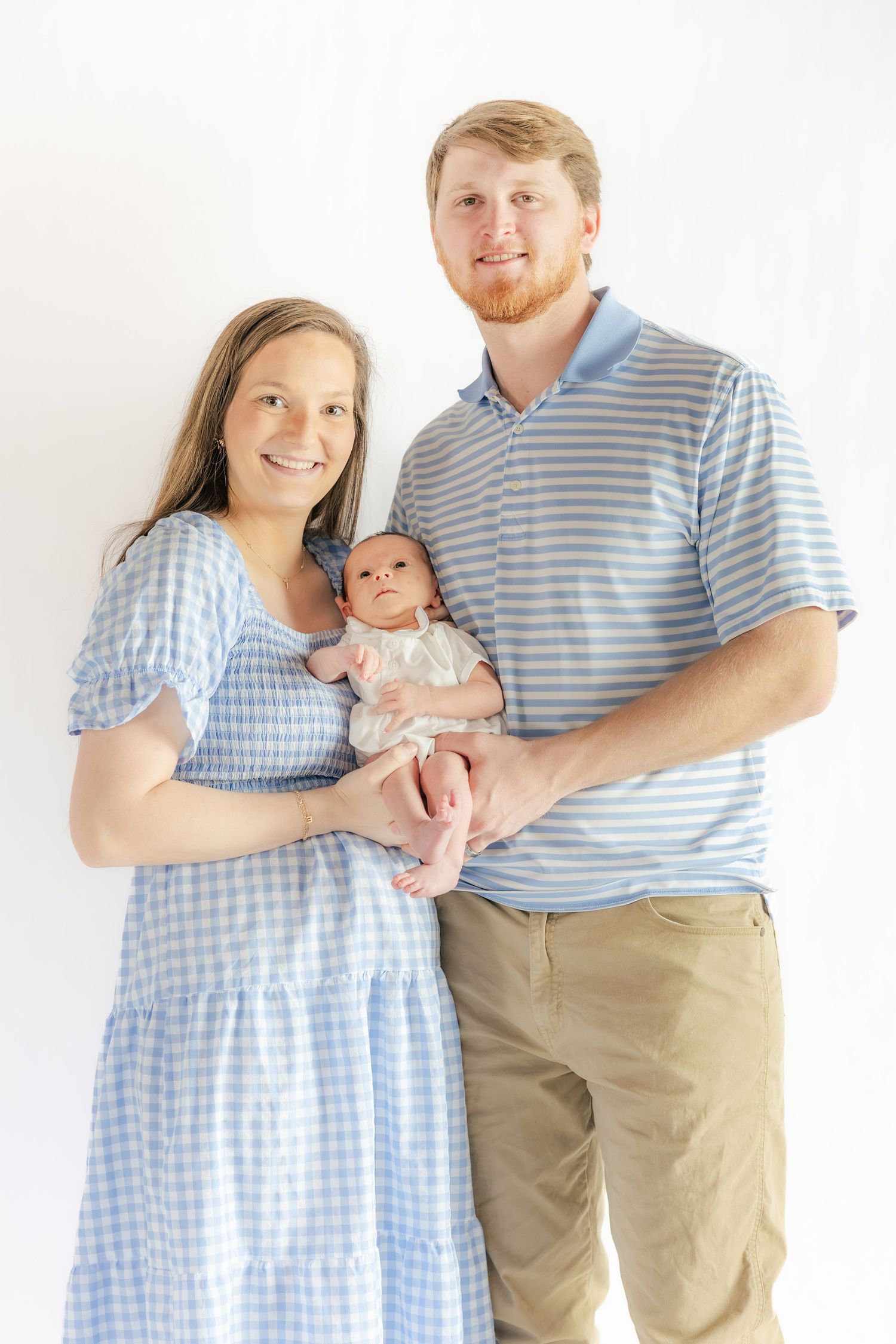 Family holding their newborn in a studio in Dothan, Alabama