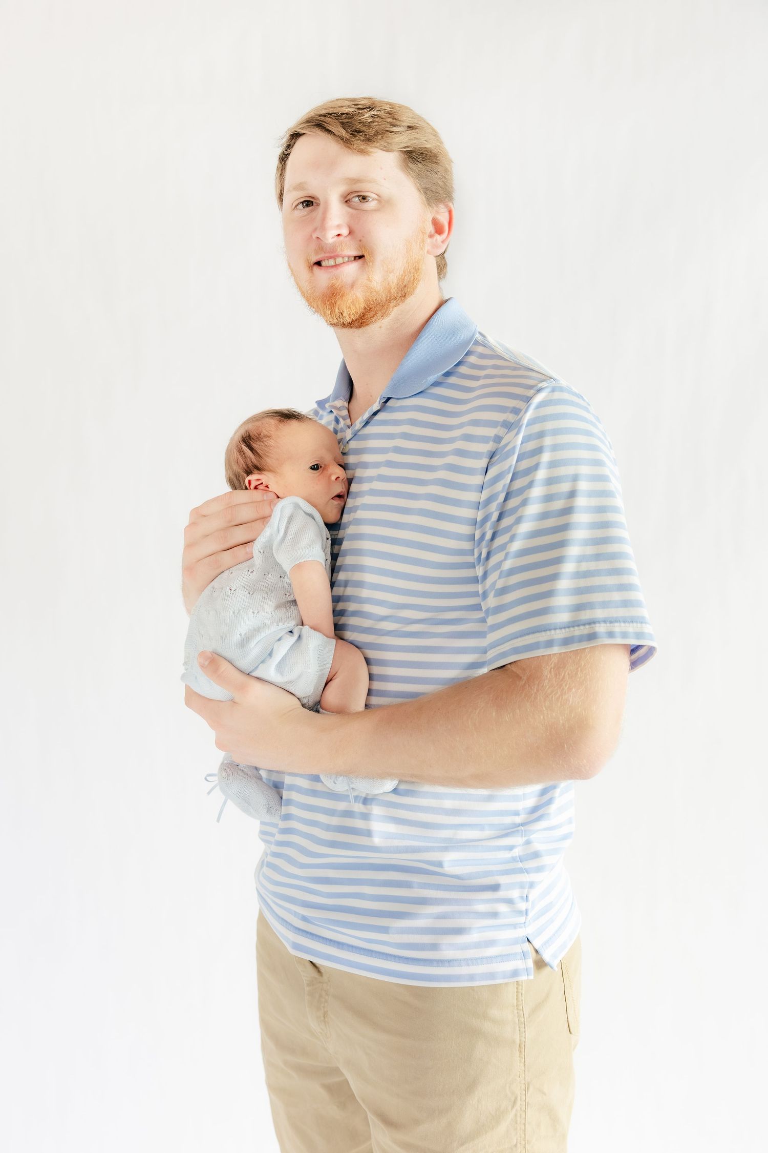 Father holding his baby in a studio in Dothan, Alabama