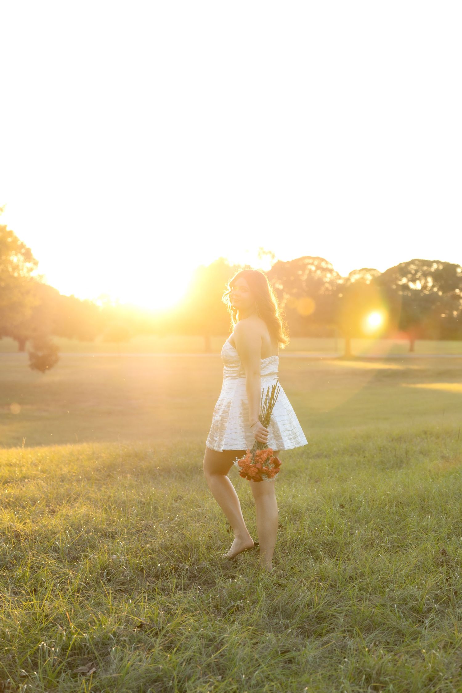 Senior pictures in a field at sunset at Troy University Dothan Campus